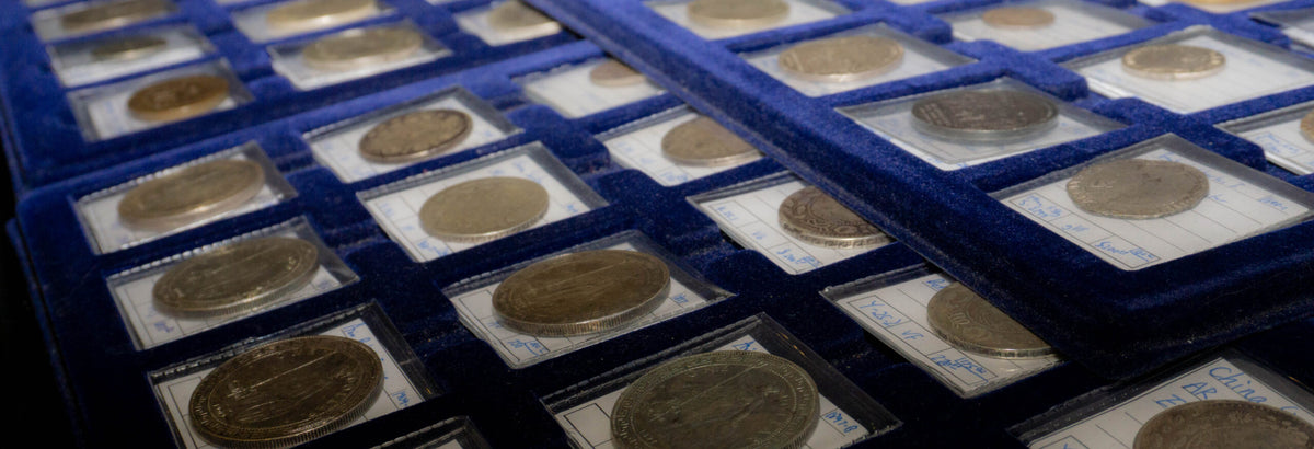 Rare coins in holders on blue velvet trays